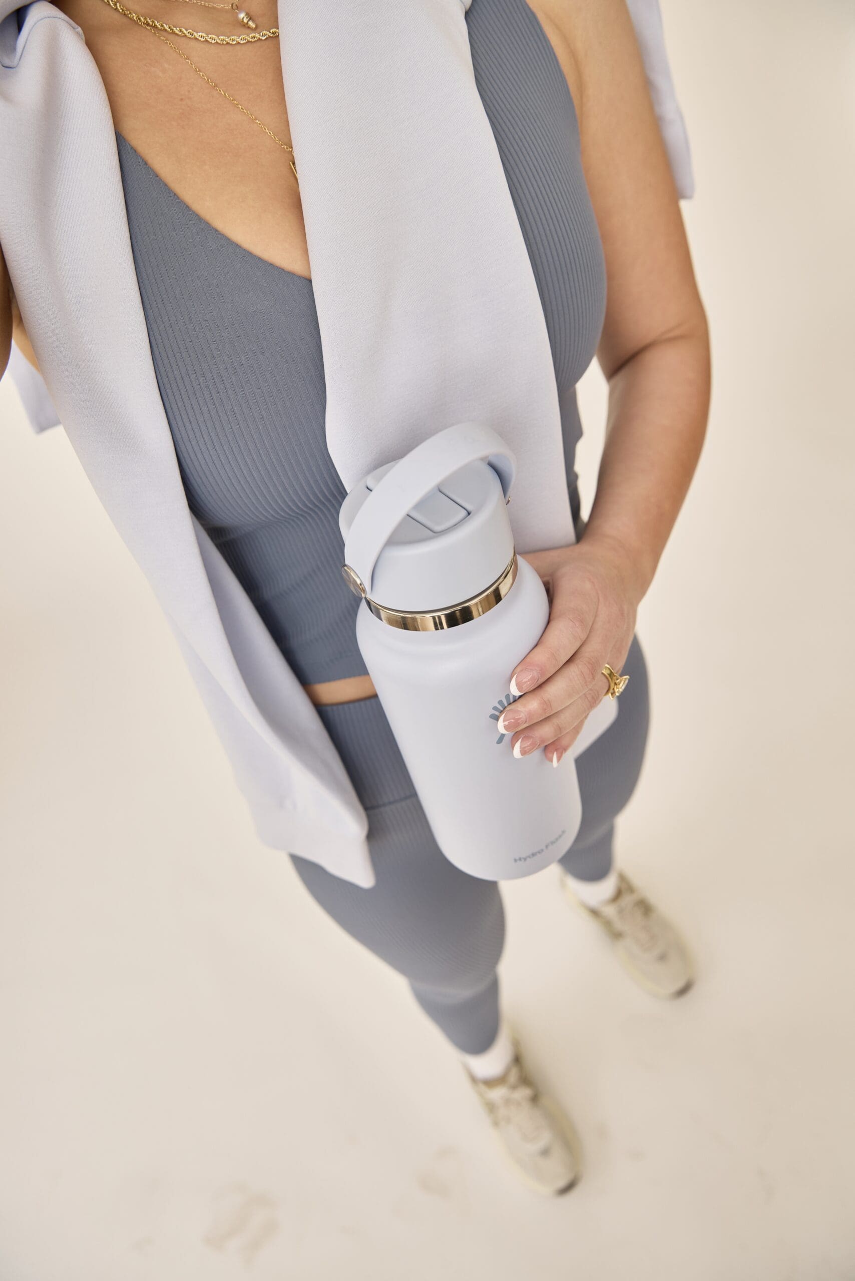 A woman sitting at a table with coffee and a notebook, reflecting on how Ozempic and body image are changing beauty standards for women.