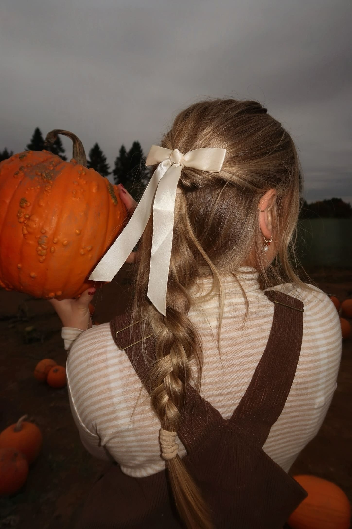 Woman on a crisp fall morning walk with headphones, listening to Fit Girl Fall playlist on Spotify
