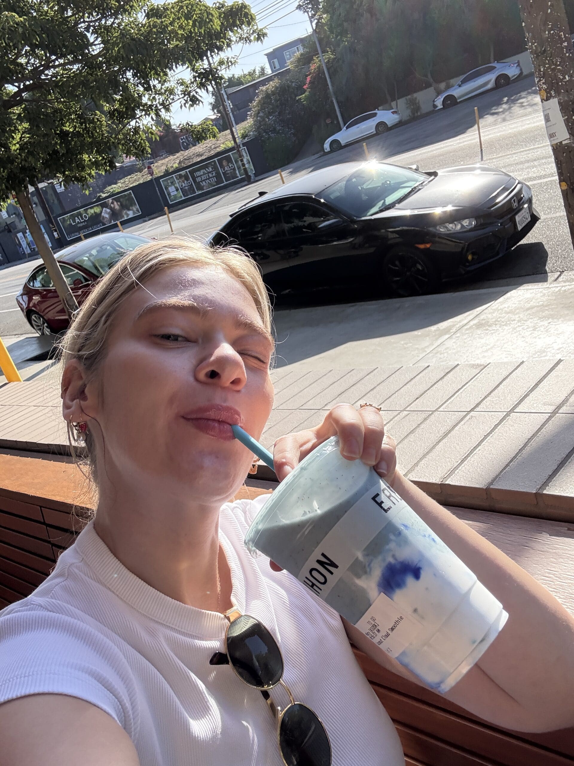Claire Rifkin, a registered dietitian, sits outside in Los Angeles sipping Erewhon’s viral blue smoothie while reflecting on wellness culture.