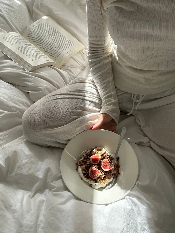 A bowl of fermented vegetables, yogurt, berries, and whole grains arranged neatly on a kitchen counter to represent gut-friendly foods.