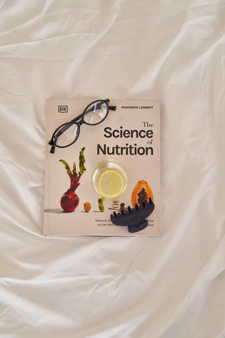 Registered dietitian Claire Rifkin reading a prenatal vitamin label while preparing for postpartum